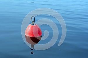 Red-orange buoy in the blue water