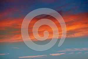 Red orange clouds in dramatic sunset sky