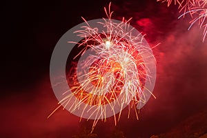 Red and orange fireworks against the backdrop of the night sky