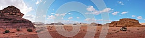 Red orange landscape in Jordan Wadi Rum desert, mountains background, small off road vehicle on side