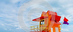 Red and Orange lifeguard hut under an overcast sky in Miami Beach