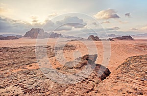 Red orange Mars like landscape in Jordan Wadi Rum desert, mountains background, overcast morning. This location was used