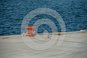 A red orange mooring bollard