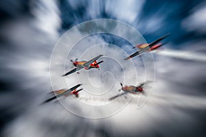 Red and Orange Planes Flying in a Stormy Sky with Motion Blur
