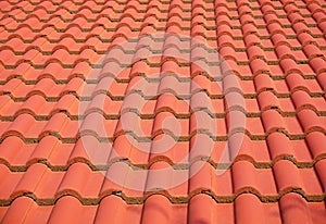 Red, orange roof tiles close up shot on a bright sunny day