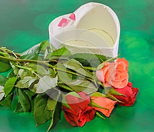 Red and orange roses flowers with heart shape box, Valentines Day, green light bokeh background, close up