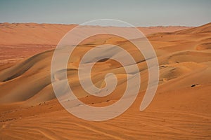 Red or orange sand dunes and hills at Al Wahiba desert in Oman