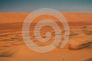 Red or orange sand dunes and hills at Al Wahiba desert in Oman