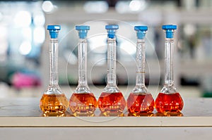 red-orange solution in cyliner flask