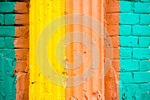 Red, Orange, yellow and blue color combination old Textured damage wall with Colorful Bricks