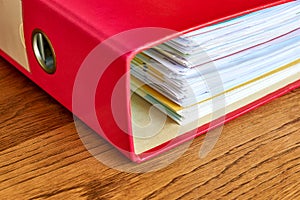 Red ordner or document binder with paperwork