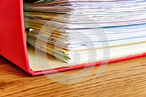 Red ordner or document binder with paperwork
