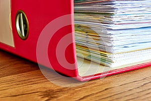 Red ordner or document binder with paperwork photo