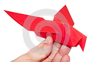 Red origami bird sitting on the hand