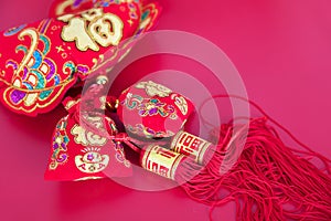 Red ornament pendant on red background. The Chinese characters in the picture mean `happiness`
