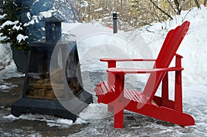 Red Outdoor Chairs with Smoking Fire Pit during Winter