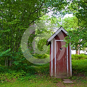 Red outhouse in the countryside of Unguri in Lithuania