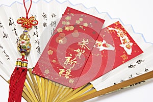 Red Packets and Trinket on Paper Fan