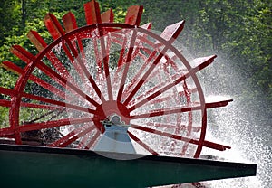 Red paddle wheel on river boat