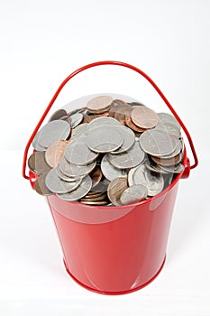 Red Pail Filled with Coins