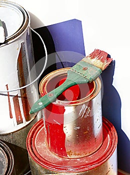 Red paint can with green brush