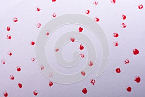 Red paint dots on a white background