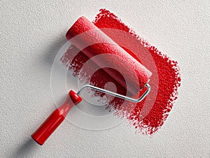 Red paint roller creating a fresh vibrant stroke on textured white wall surface in a home renovation or decorating concept