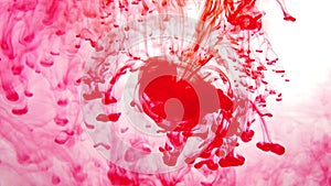 Red paint in the water abstract background. ink in fluid. colorful splashes in liquid