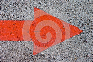 Red Painted Arrow on Concrete