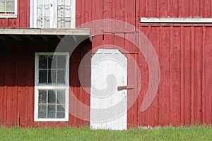 Red painted barn with white door and window trim
