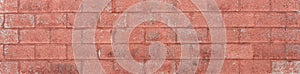 Red painted concrete block wall panorama, weathered urban texture, creative copy space
