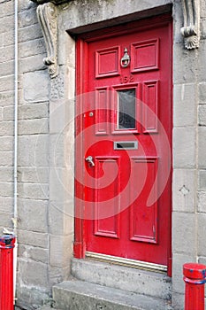 Red painted door and bollards