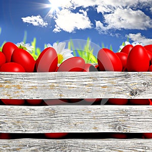 Red painted Easter eggs in wooden container