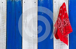 Red paisey bandanna hanging on wood door