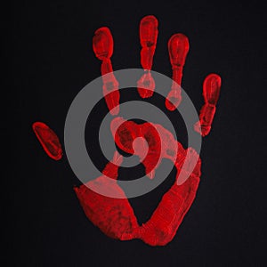 Red palm print on black background with heart, stop bloodshed and war, peace concept