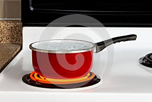 Red Pan With Boiling Water On Top of Stove