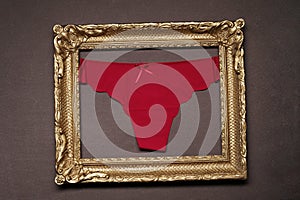 red panties in a wooden photo frame