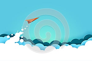 Red paper airplane flying from clouds on blue sky background. photo