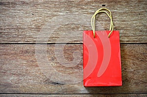 Red Paper bag on a wooden texture