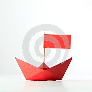 Red paper boat with flag