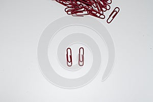 The red paper clip put on white background