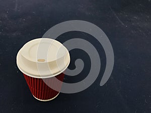 red paper coffee cup with a white plastic lid