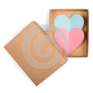 Red paper heart in cardboard box with open lid isolated on white. Flat lay