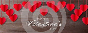 Red paper hearts hanging on vintage wooden background, Valentine concept
