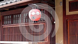 Red paper lantern outside a teahouse in gion, kyoto