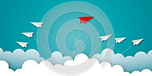 Red paper plane change direction from group on blue sky background as metaphor for business creativity new idea.