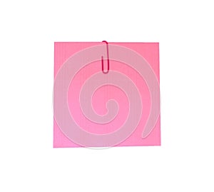 A red paperclip with blank pink notepaper. Pink sheet for your message or adding more text. Memo note with paper clip