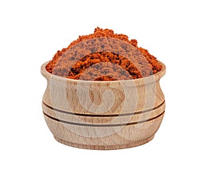 Red paprika powder in wooden bowl isolated on white background