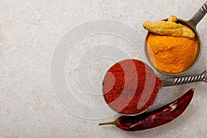 Red paprika and turmeric powder on the table. Top view.