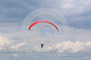 Red paraglider in a blue sky